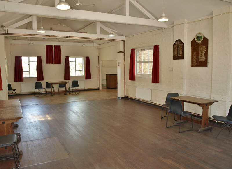 a picture of a hall with red curtains